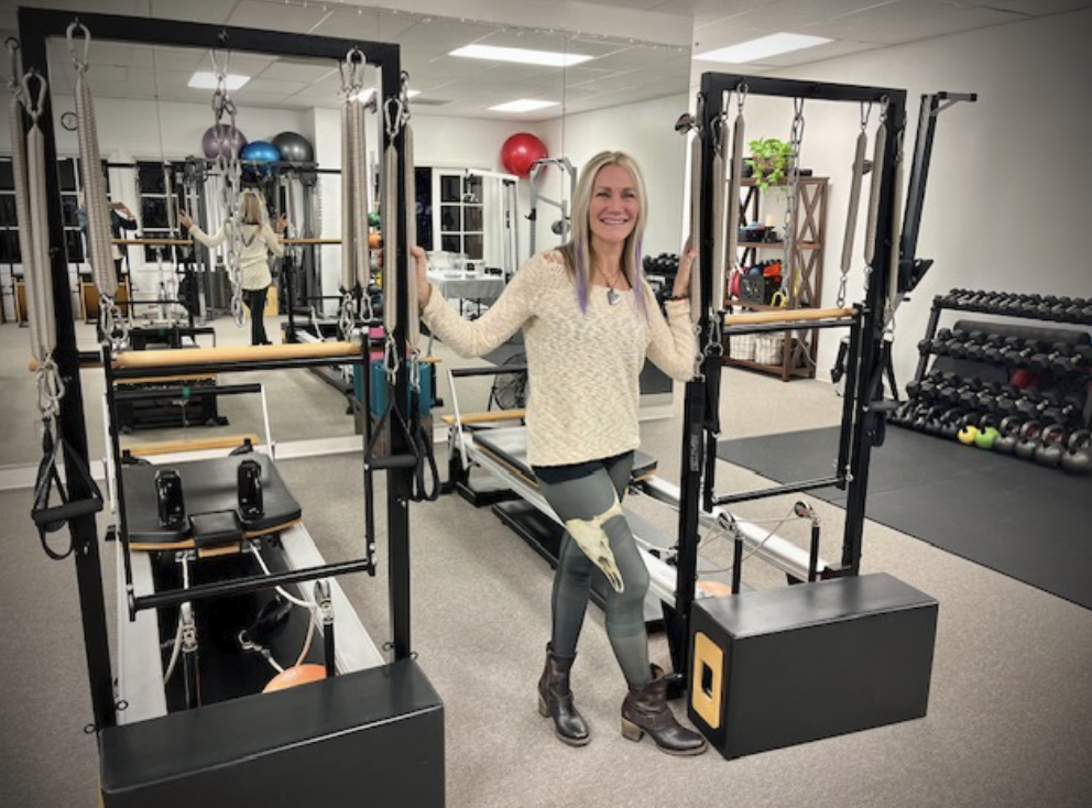 Colleen Naus among the Pilates reformers and tower conversions at pillarPERFORMANCE in Carlsbad California