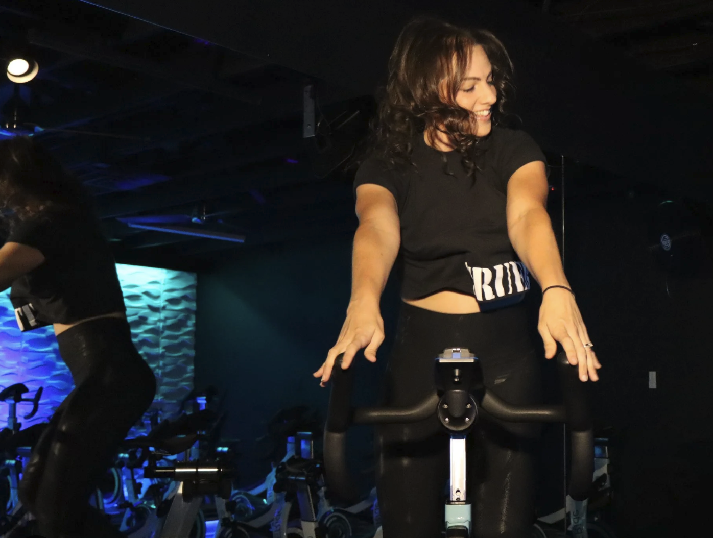 Rider immersed in a TRUE Ride class in the darkened studio in Redding, California