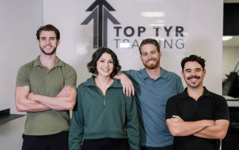 The Top Tyr Training coaching team beneath the studio signage in Torrance