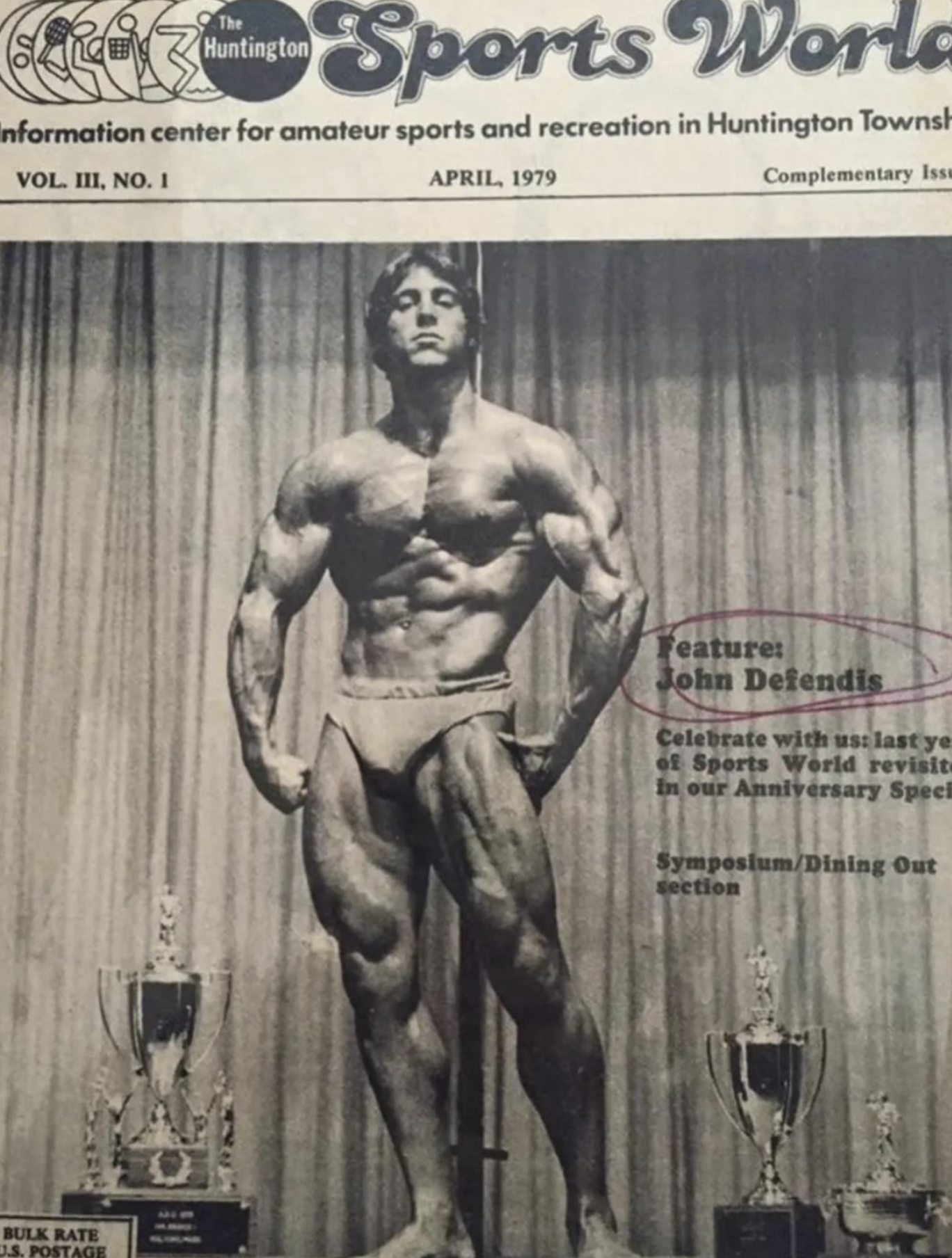 April 1979 cover of The Huntington Sports World featuring a young John DeFendis posing onstage beside trophies